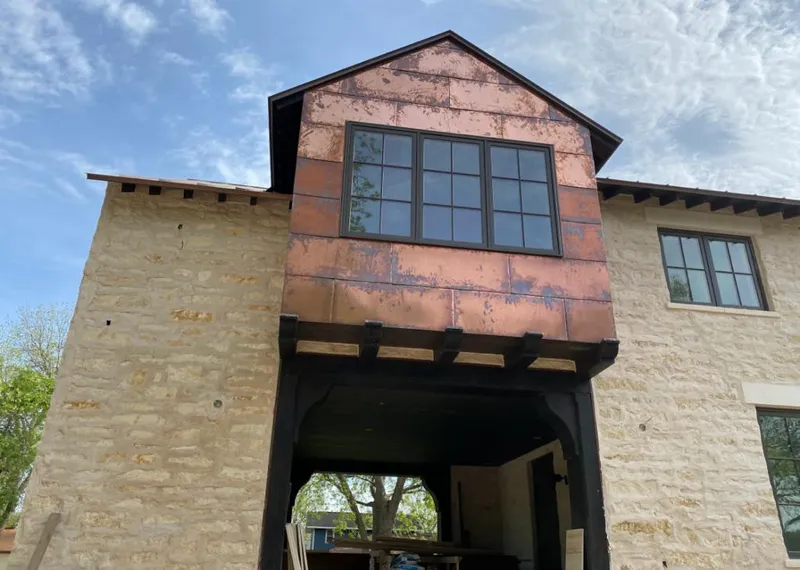 Copper metal panel facade on a stone building for Roof Repair in Fountain Inn