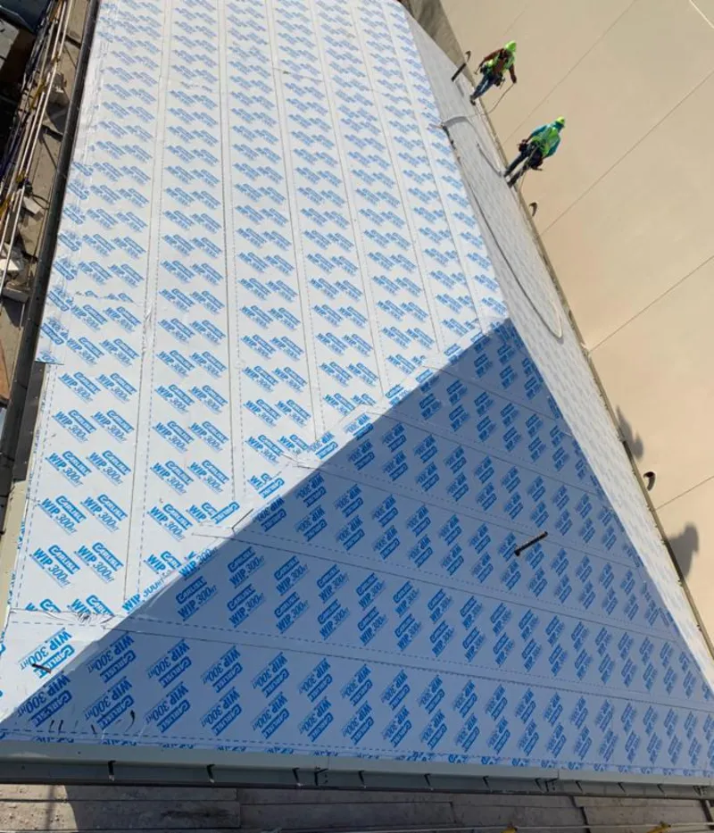 Professional roofers installing underlayment on a metal roof in Fountain Inn